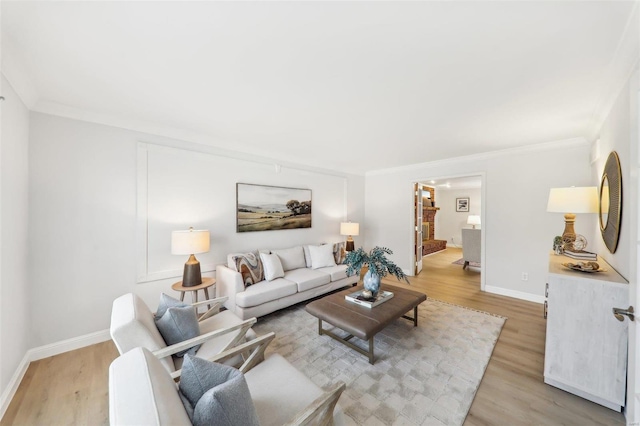 living room with light hardwood / wood-style flooring and ornamental molding