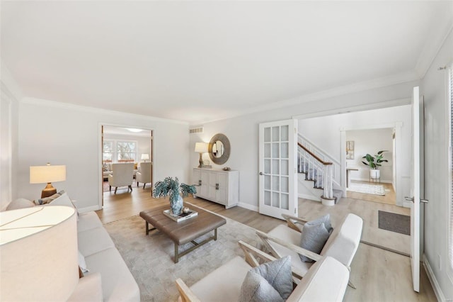 living room with ornamental molding and light wood-type flooring