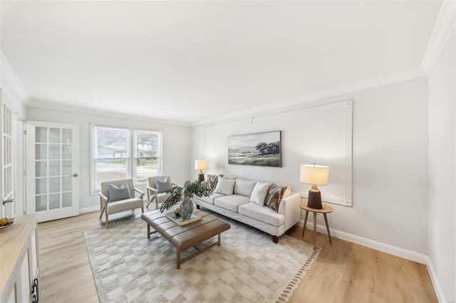 living room with crown molding and light hardwood / wood-style floors