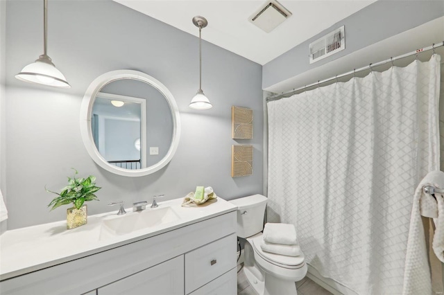 bathroom featuring vanity, curtained shower, and toilet