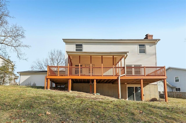 back of house featuring a yard and a deck