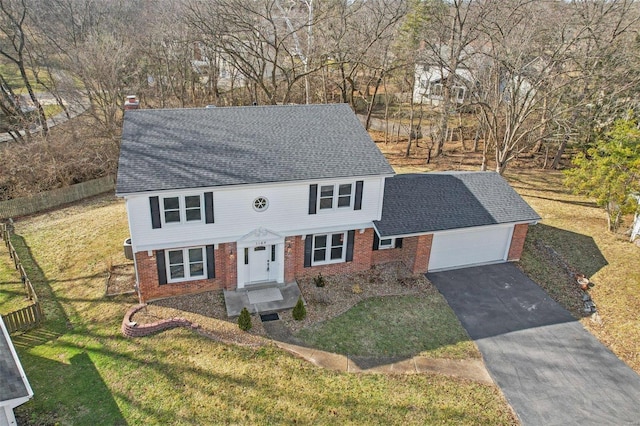 view of front of house featuring a garage and a front lawn