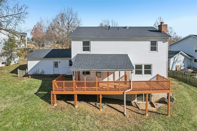 rear view of property with a deck and a lawn