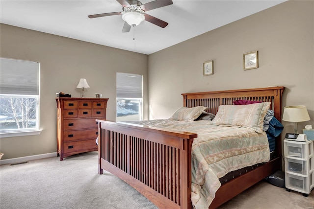 bedroom featuring light colored carpet and ceiling fan