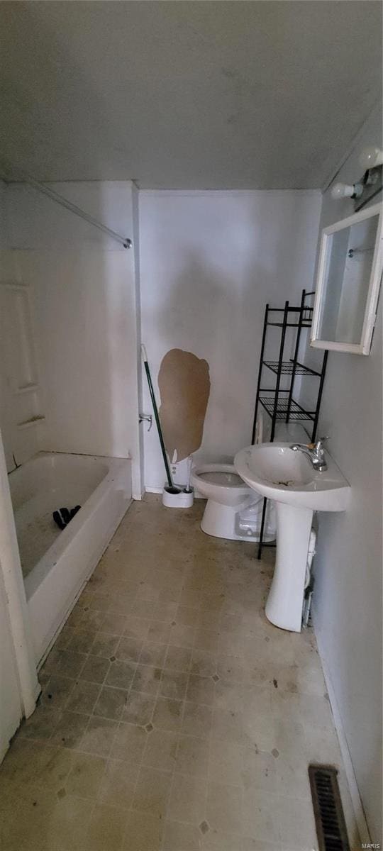 bathroom with toilet and shower / bath combination