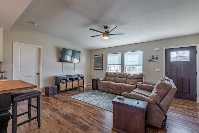 living room with ceiling fan and dark hardwood / wood-style flooring