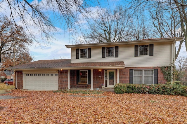 view of property with a garage and a porch