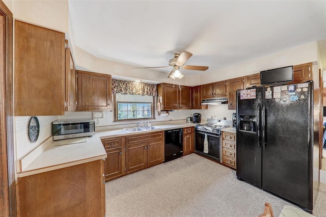 kitchen featuring ceiling fan, sink, and black appliances