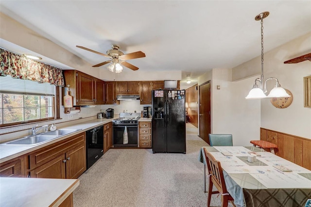 kitchen with hanging light fixtures, sink, ceiling fan, and black appliances