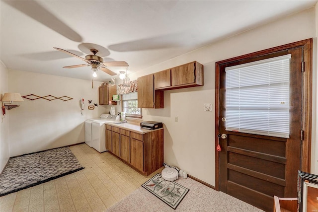 laundry area with sink, washing machine and dryer, cabinets, and ceiling fan