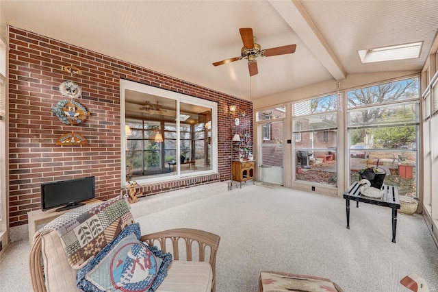 sunroom featuring vaulted ceiling with skylight and ceiling fan