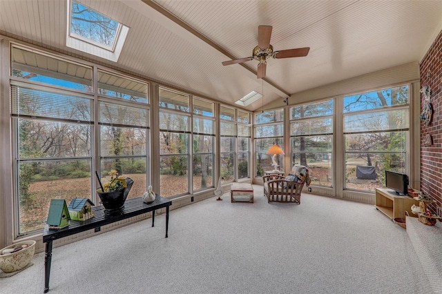 sunroom / solarium with a wealth of natural light, lofted ceiling with skylight, and ceiling fan