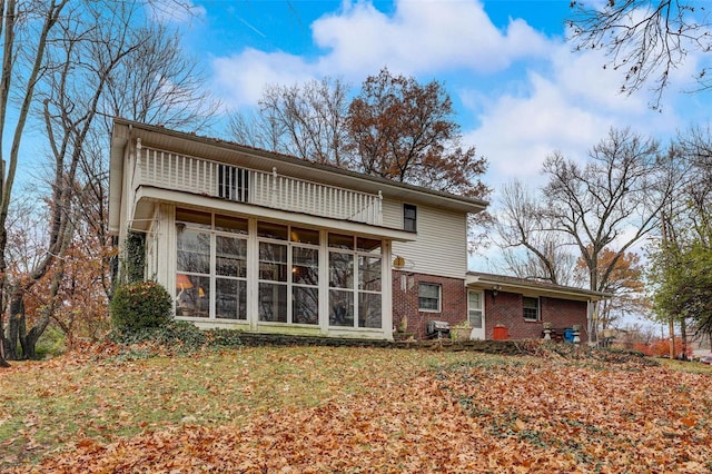 rear view of property with a sunroom