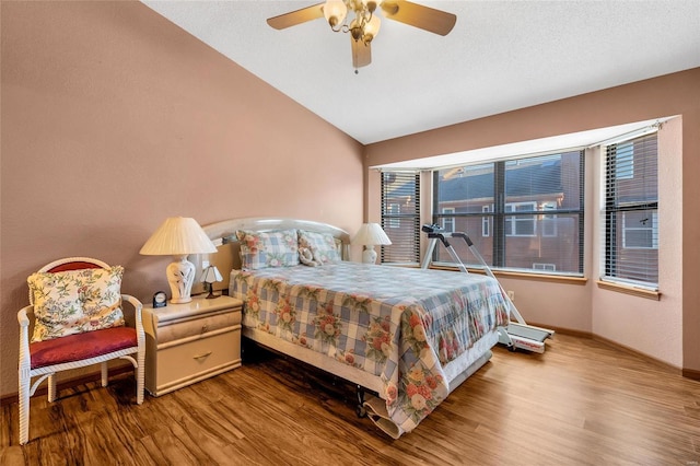 bedroom featuring hardwood / wood-style flooring, vaulted ceiling, and ceiling fan