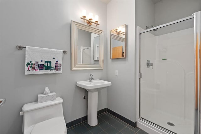 bathroom with toilet, tile patterned floors, and a shower with shower door