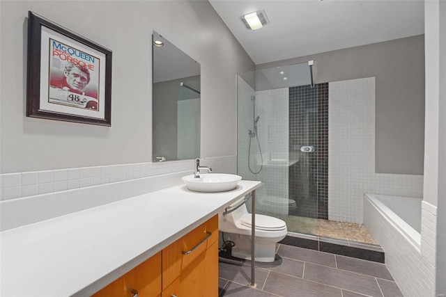 full bathroom with tile patterned floors, toilet, independent shower and bath, and vanity