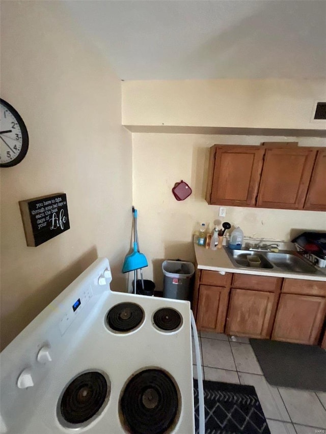 kitchen featuring sink and light tile patterned floors