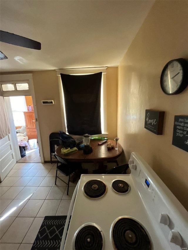 kitchen with electric range and light tile patterned floors