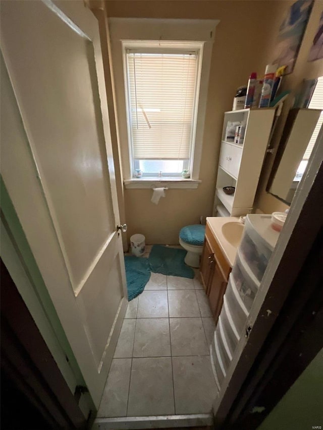 bathroom with vanity, tile patterned floors, and toilet