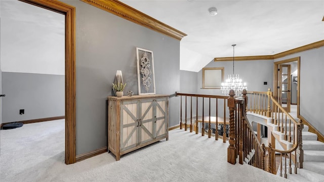 hallway with ornamental molding, carpet floors, and a notable chandelier