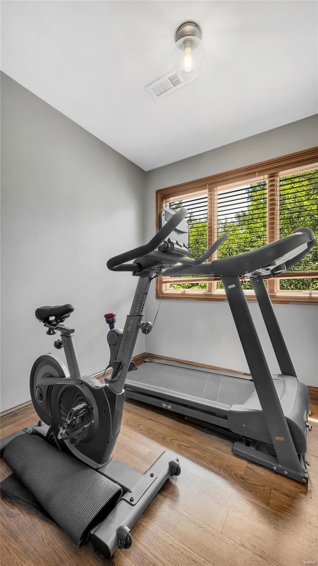 exercise area featuring hardwood / wood-style flooring