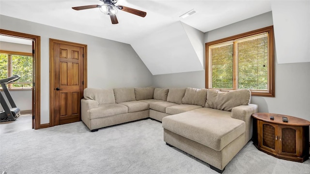 living room featuring ceiling fan, light colored carpet, and vaulted ceiling