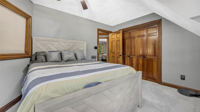 carpeted bedroom featuring vaulted ceiling, a closet, and ceiling fan