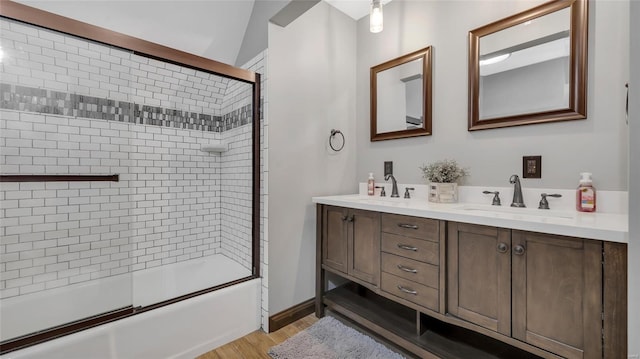 bathroom with enclosed tub / shower combo, vanity, and hardwood / wood-style floors