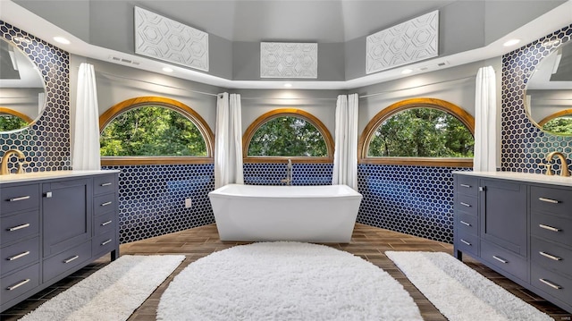 bathroom with vanity, a bathtub, and plenty of natural light