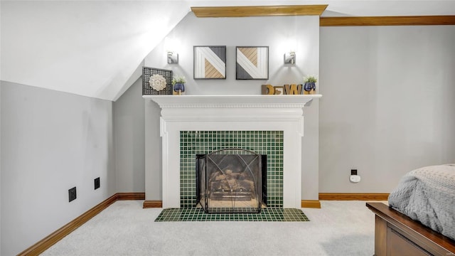 carpeted living room with vaulted ceiling and a tile fireplace