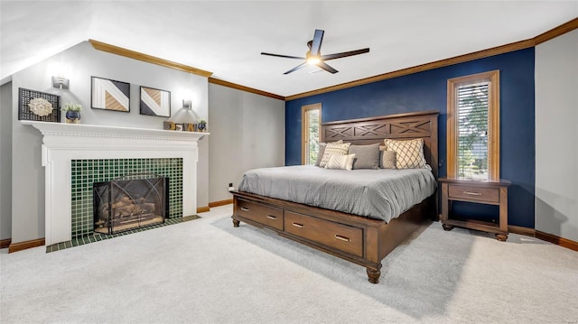 bedroom featuring crown molding, light colored carpet, a fireplace, and ceiling fan