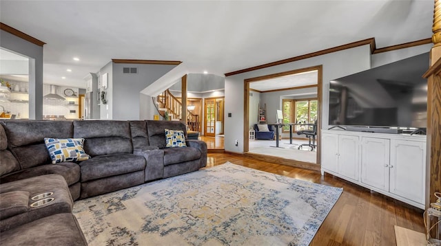 living room with crown molding and wood-type flooring