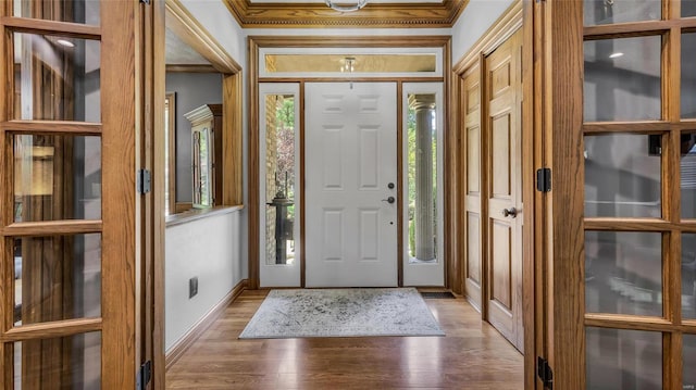 foyer with crown molding and dark hardwood / wood-style floors