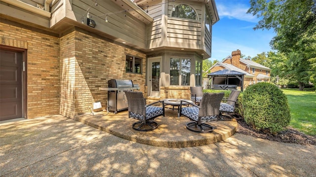 view of patio featuring a gazebo, area for grilling, and an outdoor fire pit