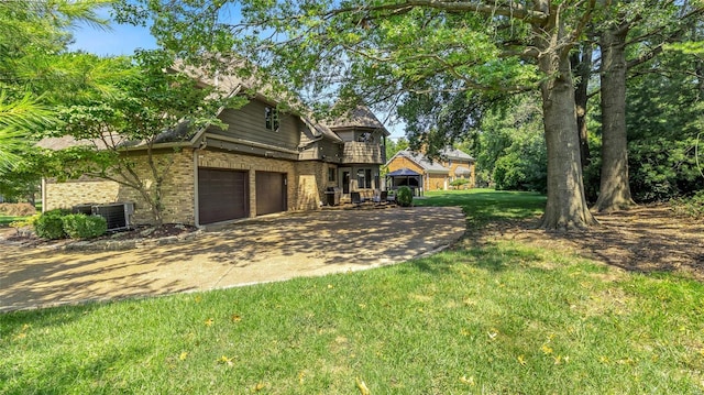 view of front of house featuring a garage and a front lawn