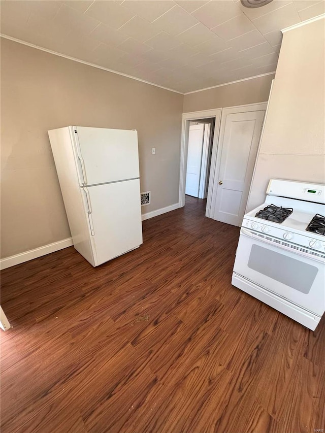 kitchen featuring white appliances and dark hardwood / wood-style flooring