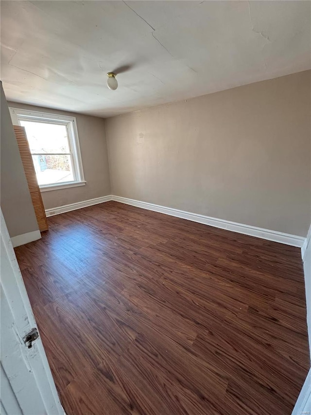 spare room featuring dark wood-type flooring