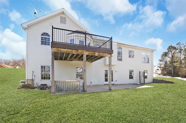 rear view of property with a lawn, a patio, and a deck