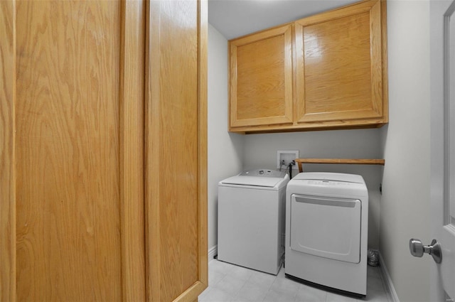 laundry room with cabinets and separate washer and dryer