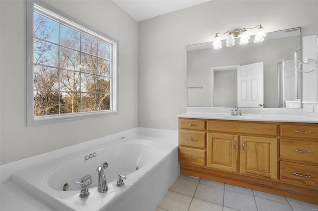 bathroom featuring tile patterned flooring, vanity, and a bathing tub