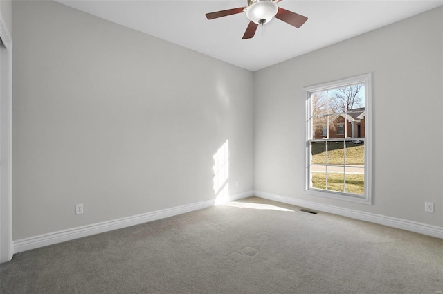 carpeted spare room featuring ceiling fan and a healthy amount of sunlight