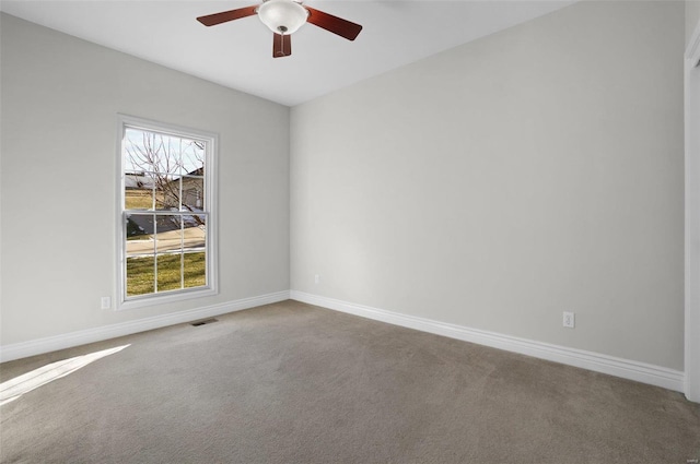 empty room with ceiling fan and carpet floors