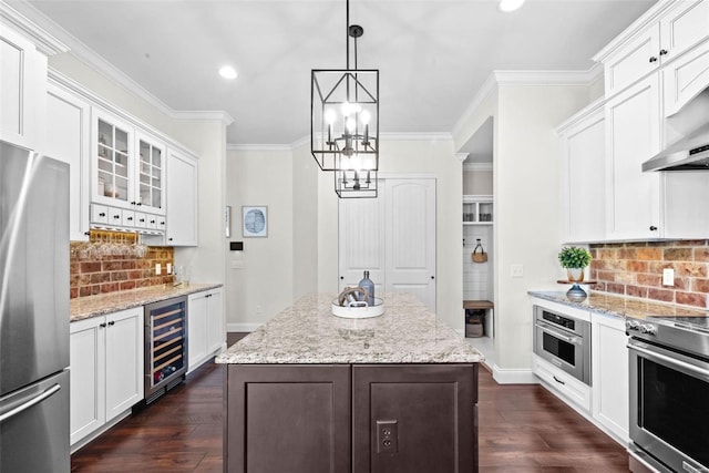 kitchen with wine cooler, a center island, pendant lighting, stainless steel appliances, and white cabinets