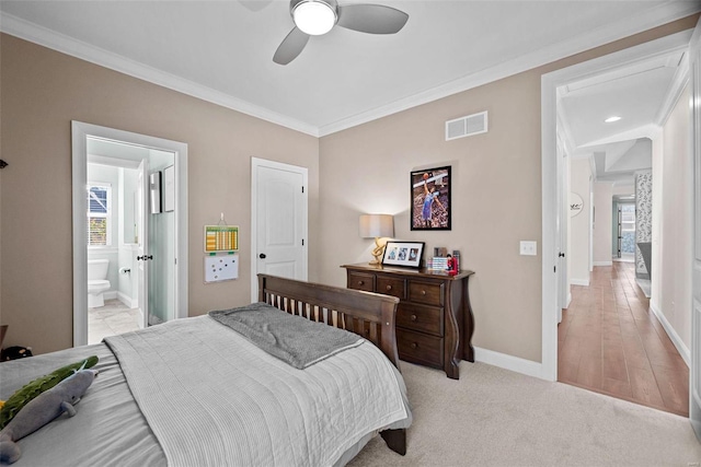 carpeted bedroom featuring crown molding, ceiling fan, and ensuite bathroom