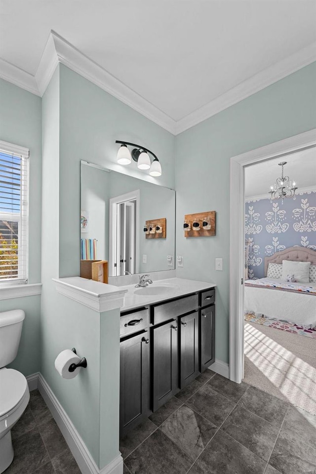 bathroom with a notable chandelier, crown molding, vanity, and toilet