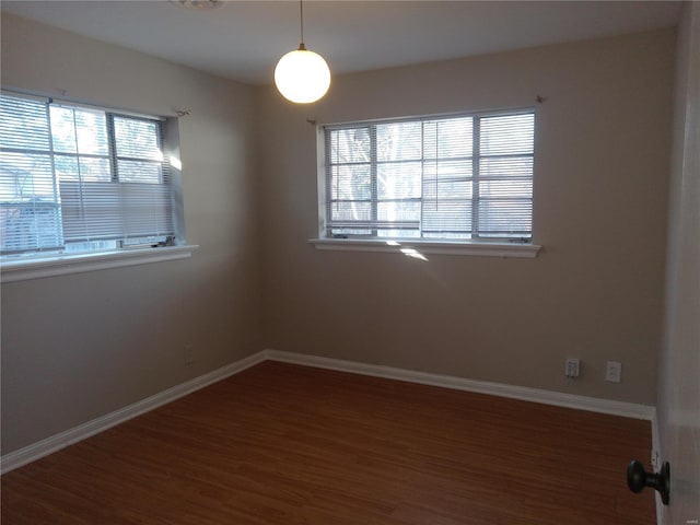 empty room featuring dark hardwood / wood-style flooring