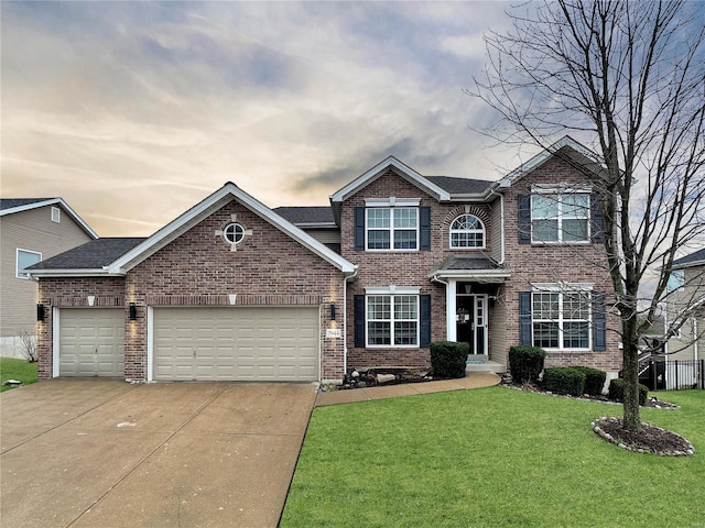 view of front of property with a garage and a yard