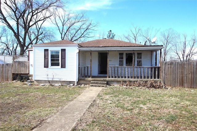 bungalow with a porch and a front lawn