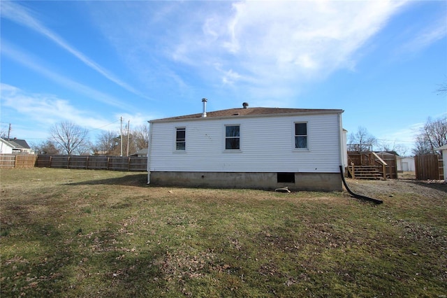 back of house with a lawn