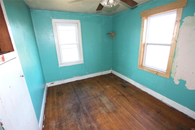 spare room featuring ceiling fan and dark hardwood / wood-style flooring